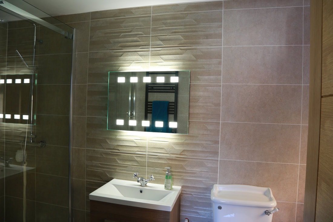 Fitted bathroom tiles and mirror